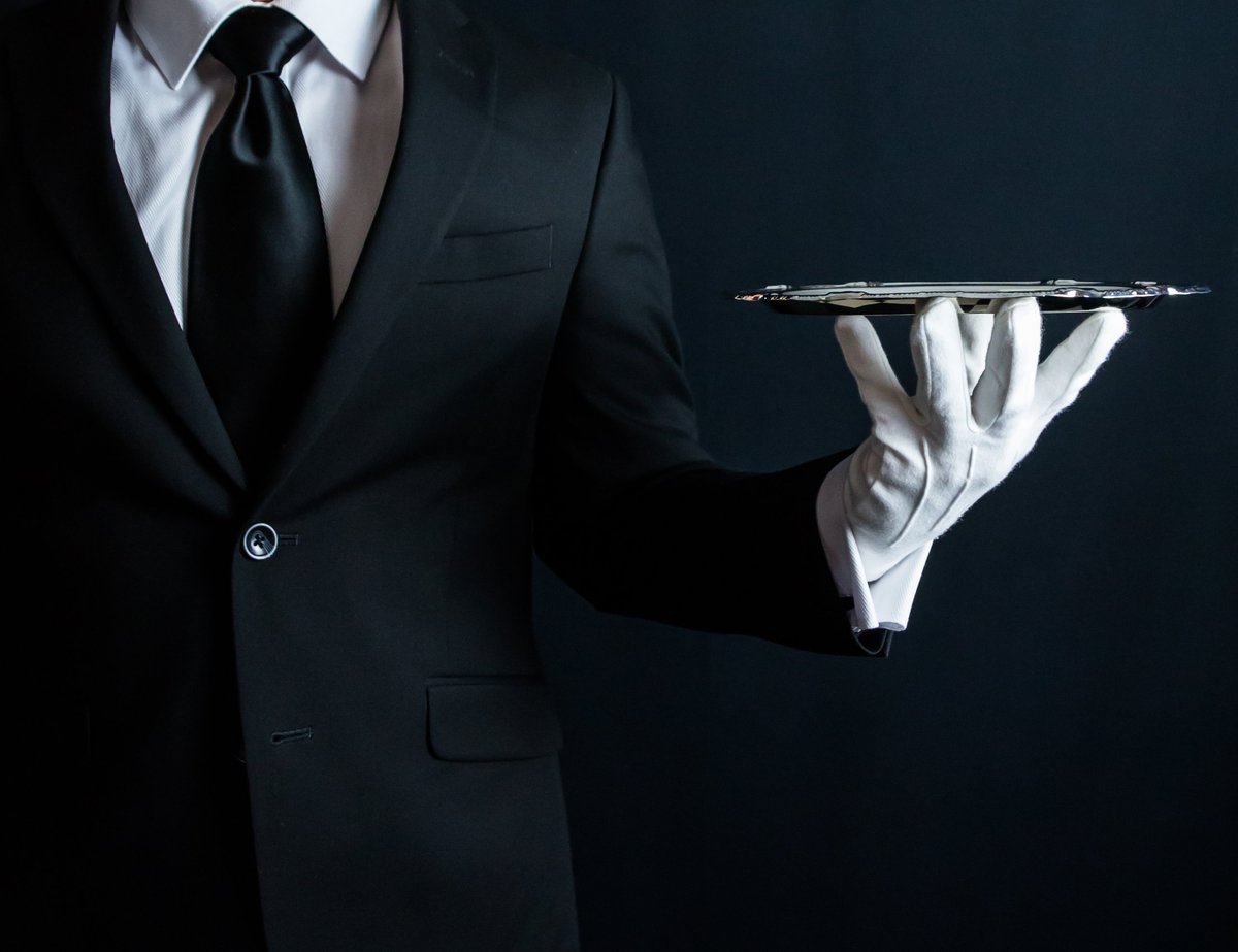 Butler in Suit and White Gloves Holding Tray